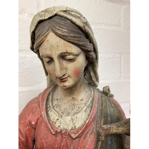 868 - An early Victorian carved wooden statuette of Madonna and child with polychrome painted body. 60cm