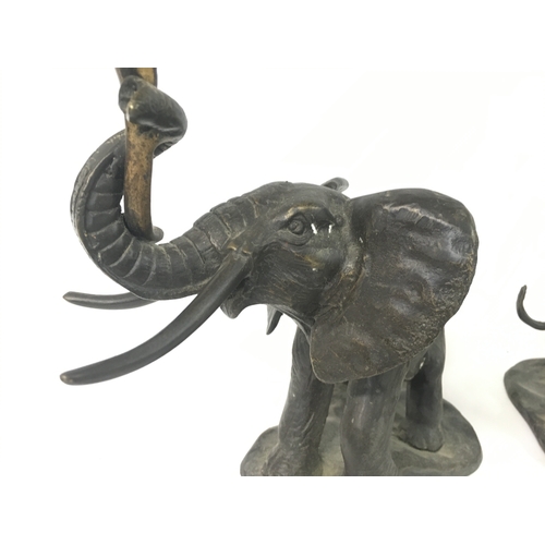 821 - A pair of spelter candle holders in the form of elephants