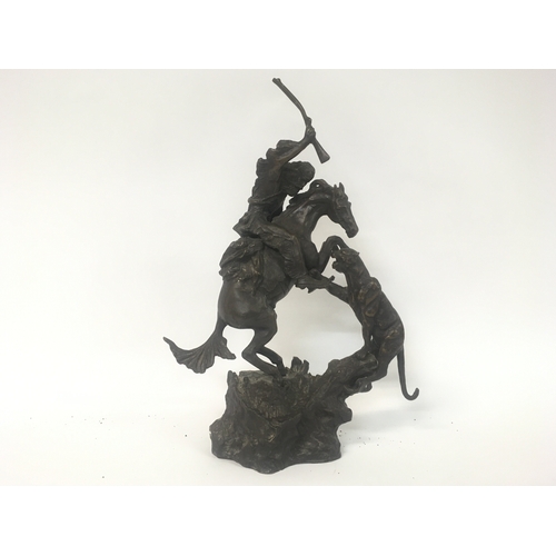 822 - A bronze figure of a Indian on horse back with tiger attacking. After Remington.40 cm .