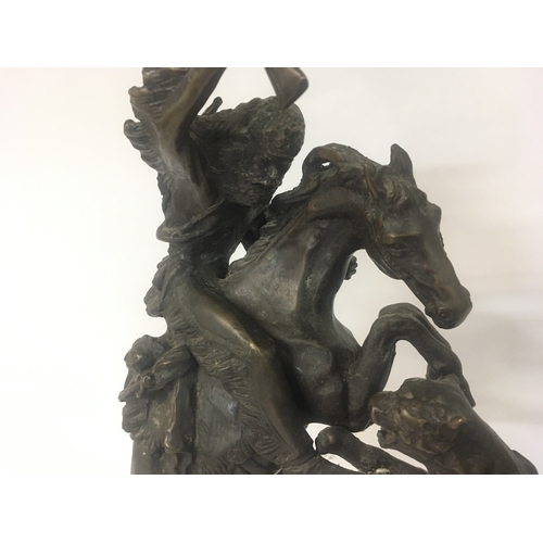 822 - A bronze figure of a Indian on horse back with tiger attacking. After Remington.40 cm .