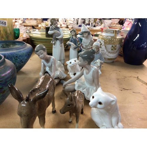 1073 - A collection of Lladro and nao figures and two beswick donkeys.