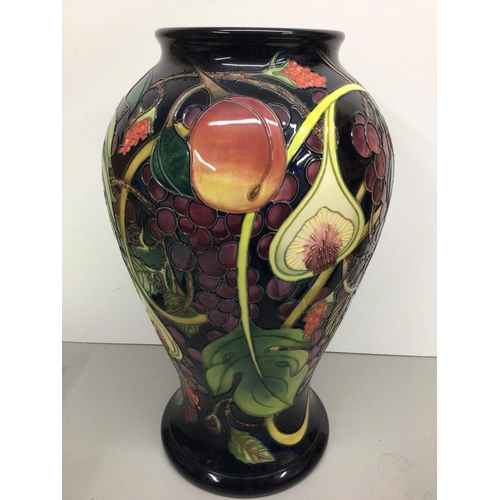 1128 - A  large Moorcroft vase of baluster form decorated with fruit and berries, by Emma Bossons, approxim... 