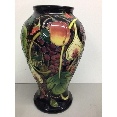 1128 - A  large Moorcroft vase of baluster form decorated with fruit and berries, by Emma Bossons, approxim... 