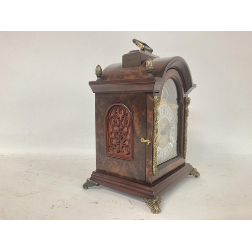 1339 - Franz Hermle Burr Walnut mantel clock with an arched dial with sun and moon phase with Roman and Ara... 