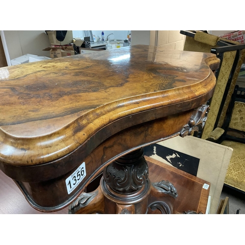 1356 - A Victorian walnut card table the twin flap top above a carved column on cabriole legs .