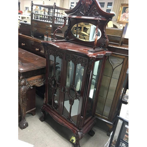 1367 - A Mahogany display cabinet with a raised mirrored back scroll supports and glazed doors on cabriole ... 