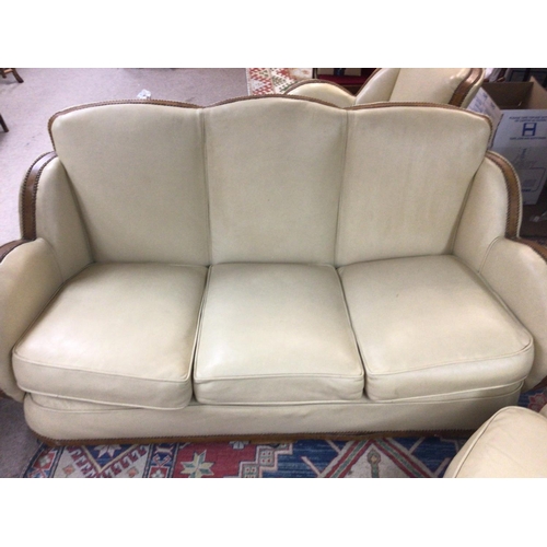 1417 - A Art Deco three piece cloud suite in cream with walnut trim , With foot stool.