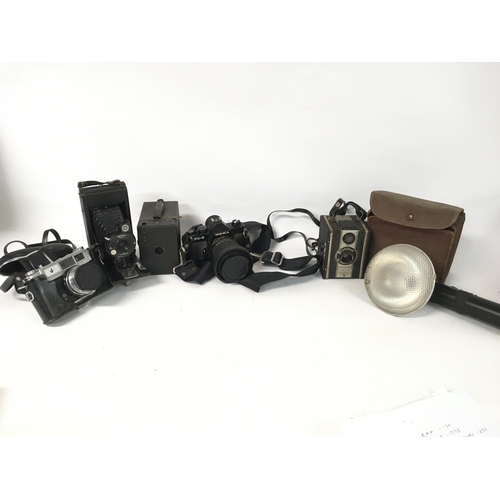 1810 - A collection of vintage cameras and film cameras including a Yashica MAT-124, Yashica FX-3, Canon AS... 