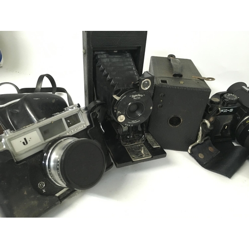 1810 - A collection of vintage cameras and film cameras including a Yashica MAT-124, Yashica FX-3, Canon AS... 