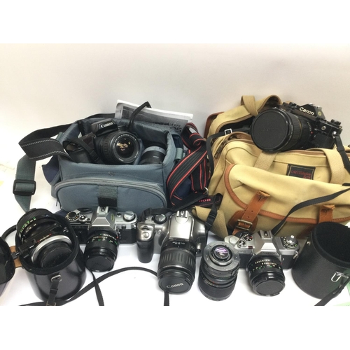 1957 - A collection of cameras and lenses comprising mainly Canon cameras, a boxed Sigma telephoto lens etc... 