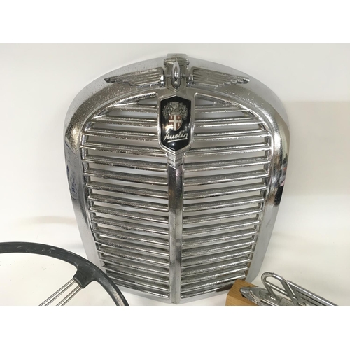 703 - Collection of Austin display ornaments including a grill, badge and steering wheel