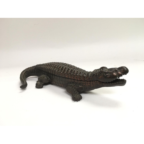 714 - A cast iron inkwell in the form of a crocodile inset with two bottles, approx length 25cm.