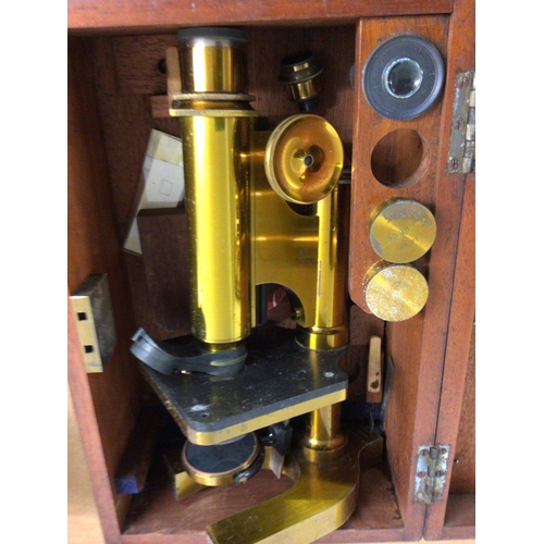 772 - A brass microscope in a mahogany case .