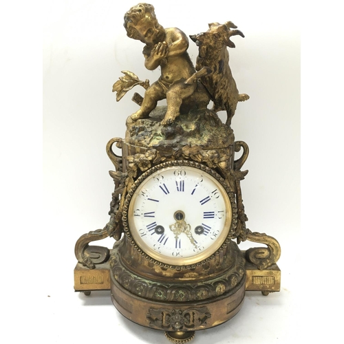 780 - Gilt ormolu clock featuring a Putto and goat. Approximately 32x14x23cm