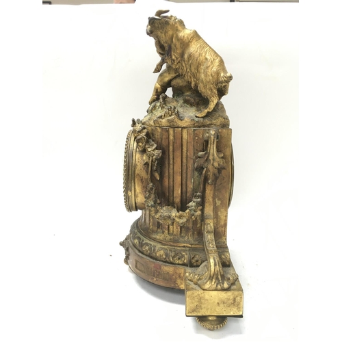 780 - Gilt ormolu clock featuring a Putto and goat. Approximately 32x14x23cm