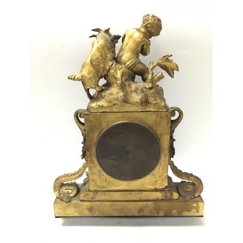 780 - Gilt ormolu clock featuring a Putto and goat. Approximately 32x14x23cm