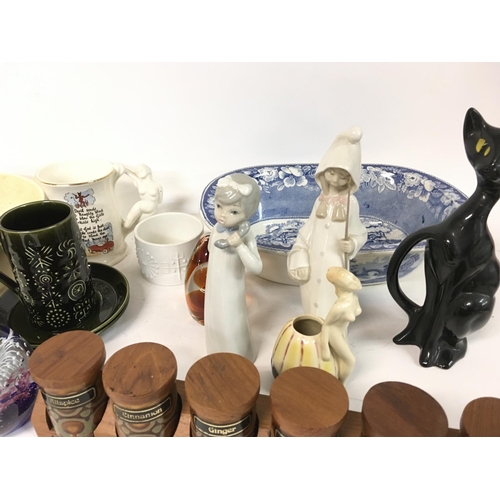 865 - An assortment of ceramics including figurines by Lladro, Casades. Portmeirion totem kitchenware, pap... 