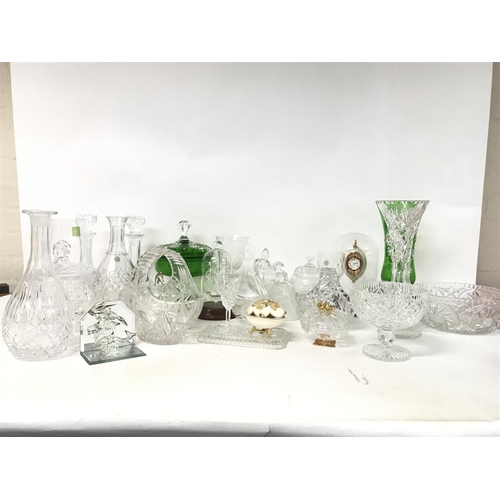 914 - A collection of cut glass ornaments including decanters, glasses