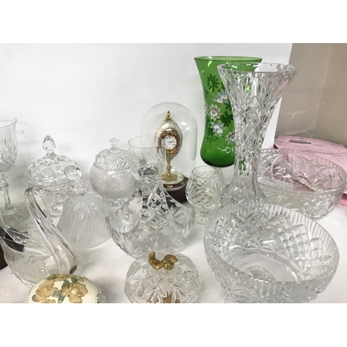 914 - A collection of cut glass ornaments including decanters, glasses