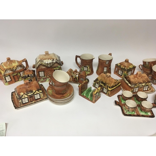 957 - A collection of cottage ware ceramics including biscuit barrels tea pots butter dishes cups saucers ... 