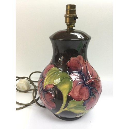 963 - A Moorcroft lamp of baluster from in hibiscus pattern, approx height 31cm. No shade.