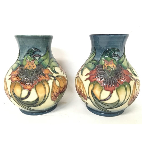 964 - Moorcroft vases, approximate heights 16cm.