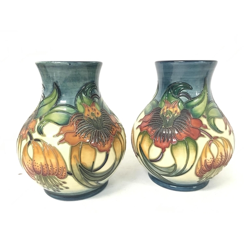 964 - Moorcroft vases, approximate heights 16cm.