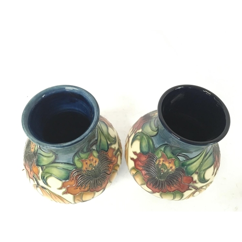 964 - Moorcroft vases, approximate heights 16cm.