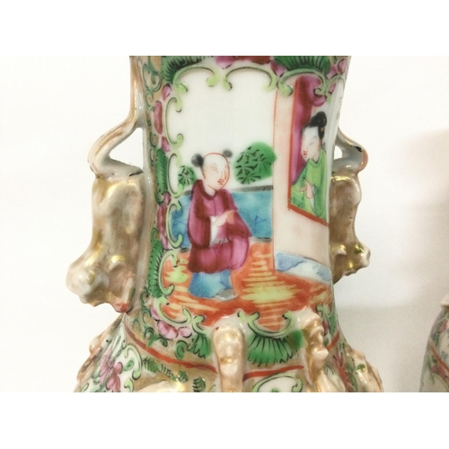 1007 - A pair of 19th century Chinese Cantonese vases decorated with Chinese figures. 26cm tall.