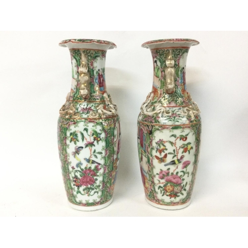 1007 - A pair of 19th century Chinese Cantonese vases decorated with Chinese figures. 26cm tall.