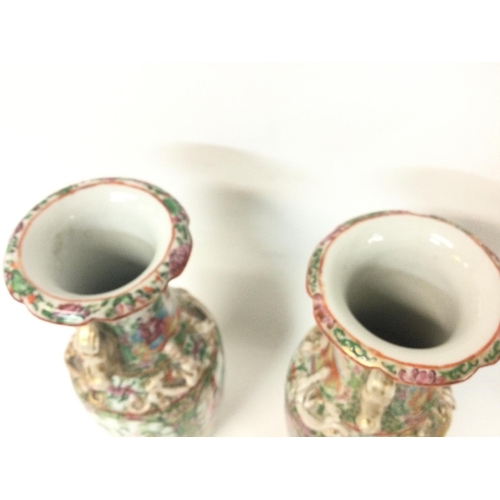 1007 - A pair of 19th century Chinese Cantonese vases decorated with Chinese figures. 26cm tall.