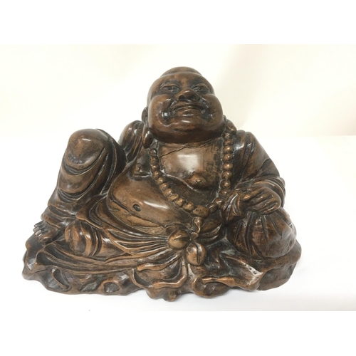 1016 - An early 20th century carved hardwood reclining Buddha with glass eyes.