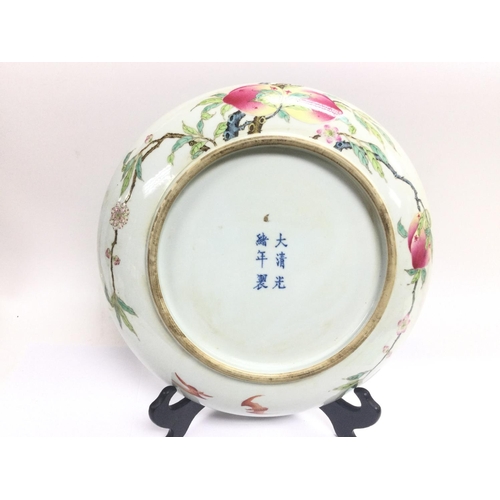 1023 - An Oriental charger decorated with fruits and bats, approx diameter 33cm. Shipping category D.