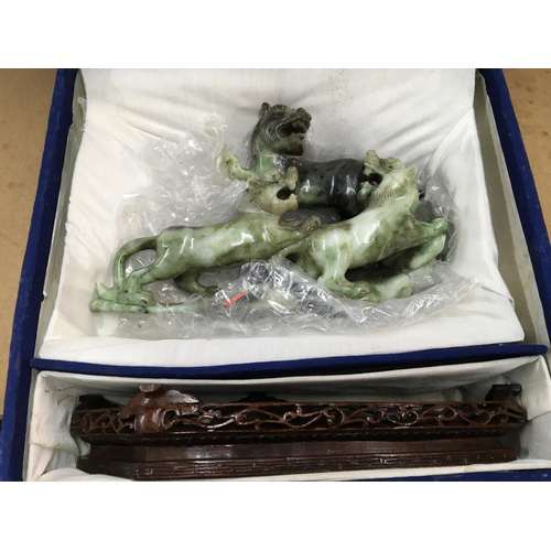 1038 - A boxed and carved Oriental soap stone figure of a Dog of Foo, with carved wooden stand