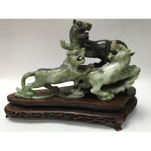 1038 - A boxed and carved Oriental soap stone figure of a Dog of Foo, with carved wooden stand