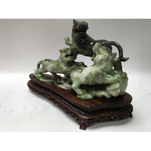 1038 - A boxed and carved Oriental soap stone figure of a Dog of Foo, with carved wooden stand