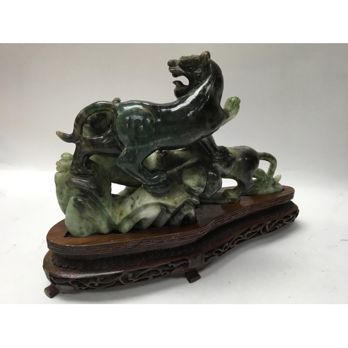 1038 - A boxed and carved Oriental soap stone figure of a Dog of Foo, with carved wooden stand