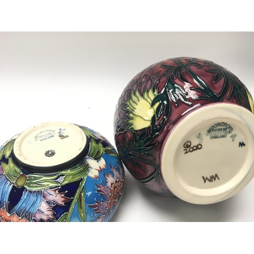 1167 - Boxed Moorcroft vases and a potted lid, boxed. Ranging from heights of 6cm to 32cm.