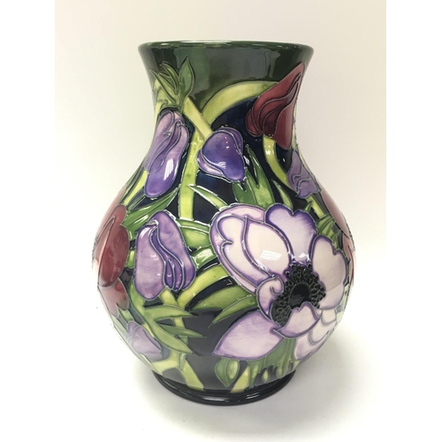 1211 - Boxed large Moorcroft Anemone tribute vase by Emma Bossons, 2002. Approximately 24cm tall.