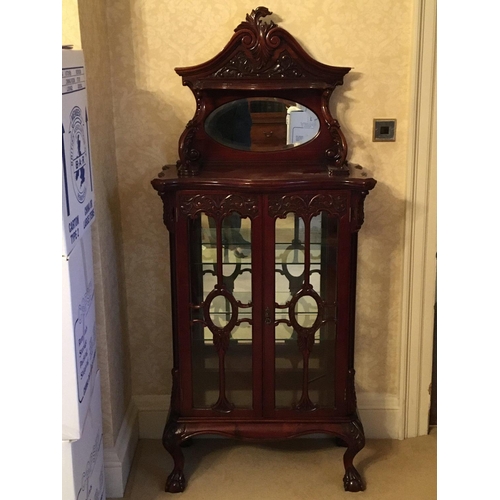 1410 - A Mahogany display cabinet with a raised mirrored back scroll supports and glazed doors on cabriole ... 