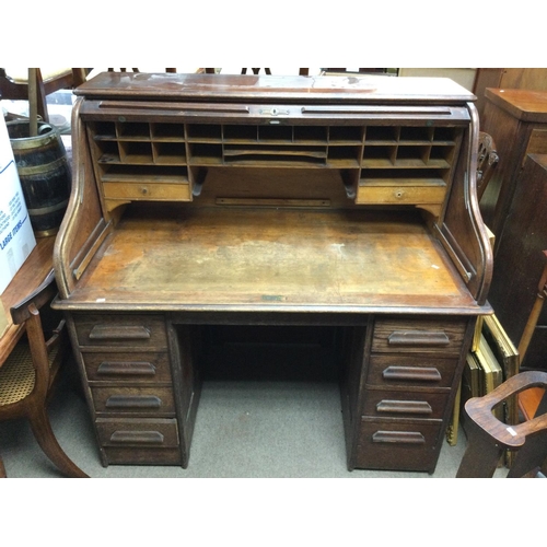 1417 - An oak American tambour desk. 123cm wide 128 high 77cm deep.