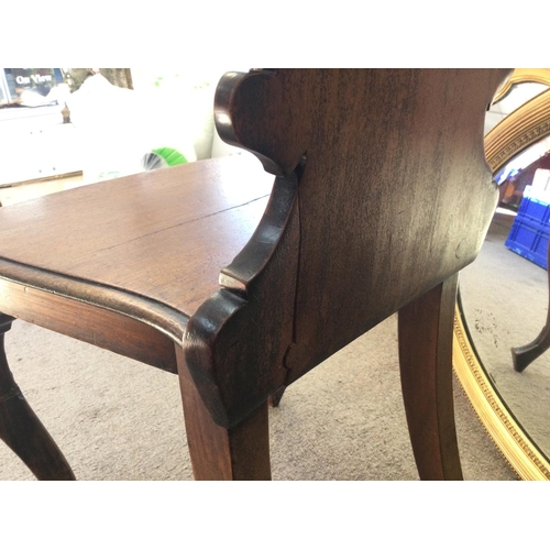 1440 - A Victorian Mahogany hall chair, in need of restoration due to cracks. 42x36x90xm approximately.