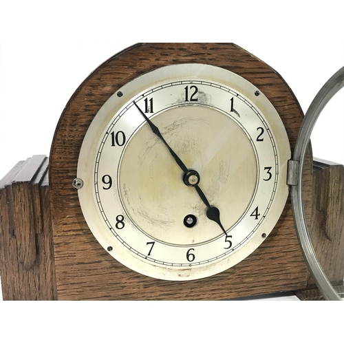 1466 - An oak mantle clock by Garrard with chrome key and pendulum