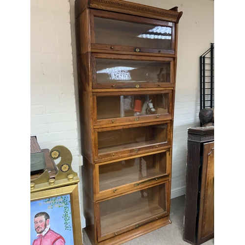 1476 - A 1940s Utility oak Lebus sectional bookcase, 220 x 88cm