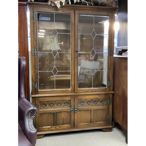 1477 - An oak glazed 2 door cabinet with lead glazed front. 161 x 107cm