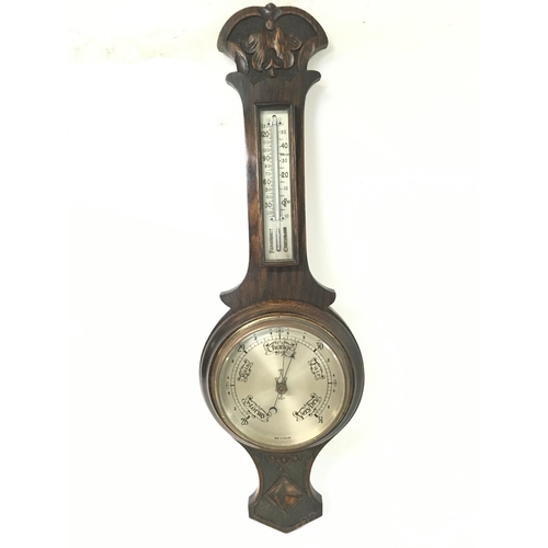 1528 - Vintage oak barometer with carved designs, approximately 68cm long.