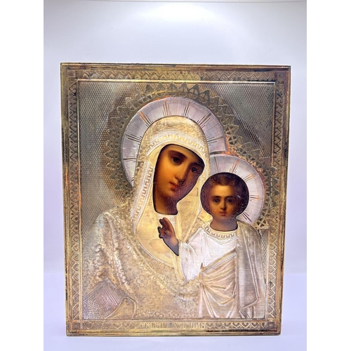 851 - A late 19thC cased Russian icon depicting the Madonna and Child with a Russian hallmarked silver cov... 