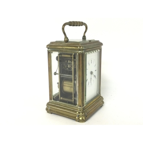 873 - A brass strike repeating carriage clock, with key. Approximately 9x8x16cm. (B)