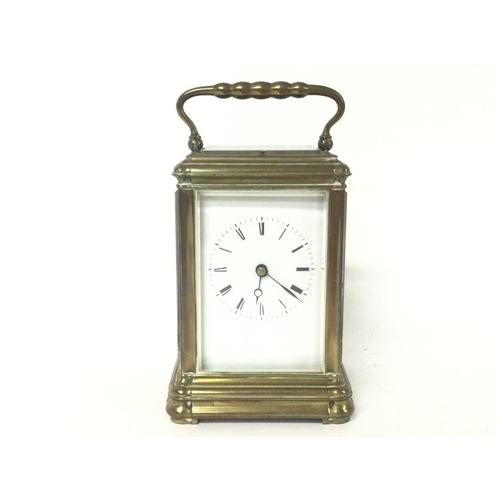 873 - A brass strike repeating carriage clock, with key. Approximately 9x8x16cm. (B)