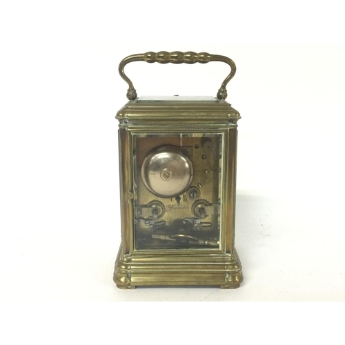 873 - A brass strike repeating carriage clock, with key. Approximately 9x8x16cm. (B)